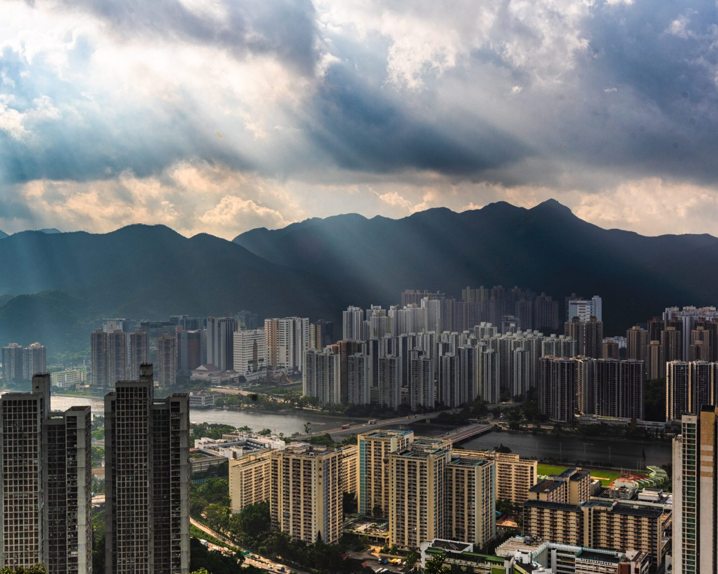 beautiful aerial shot of apartment buildings area in an urban city with amazing clouds and sunlight